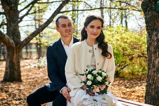 Couple in love close-up portrait. Young male and woman just married. Concept of happy family. Modern family outdoor. Adorable family demonstrate love and care. Autumn vacation.