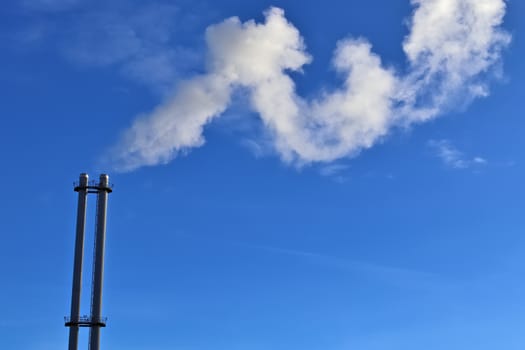 Industry pollution from factories in a blue sky