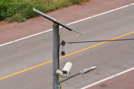 CCTV camera security with Solar panel and street lamp in a big city (All in one)