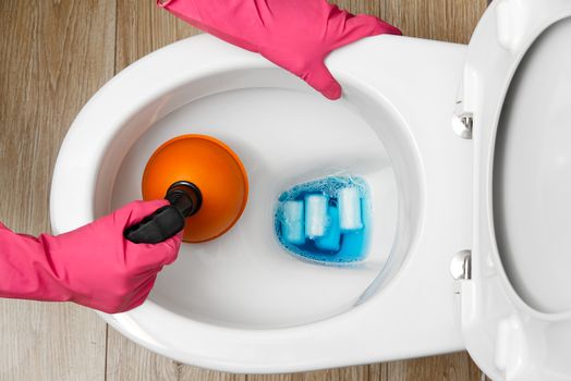 Women cleaning clogged toilet. broken overflowing toilet. home cleaning service concept