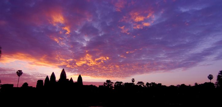 Silhouette of Angkor Wat temple in the sunrise panorama