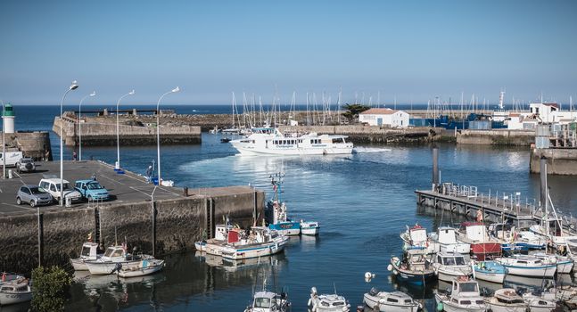 Port Joinville on the island of Yeu - September 17, 2018: view of the small port where maneuver fishing boats, tourism boats and sea shuttles going to the mainland on a summer day