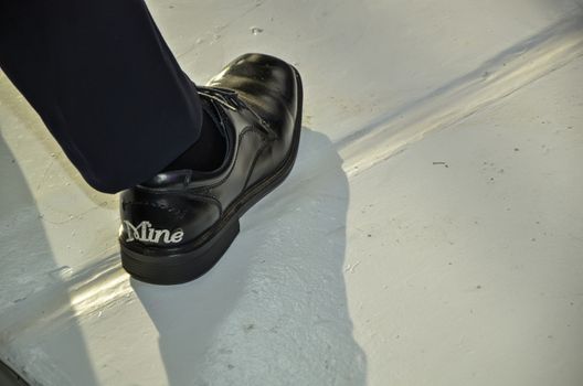 Boyfriend shoe with message that says "mine"