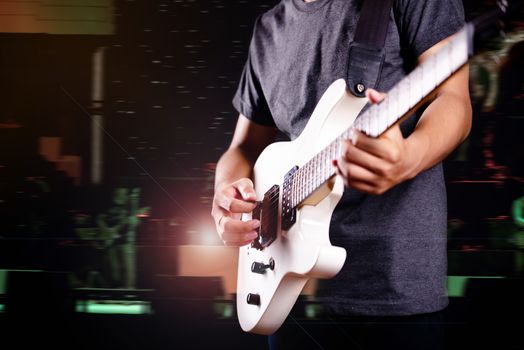 young man in black leather jacket with electric guitar in studio