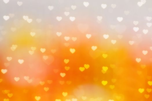 blur heart shape lights bokeh orange and gold background, colorful bokeh lights heart soft wallpaper, sparkles heart shape bright bokeh valentine romantic background