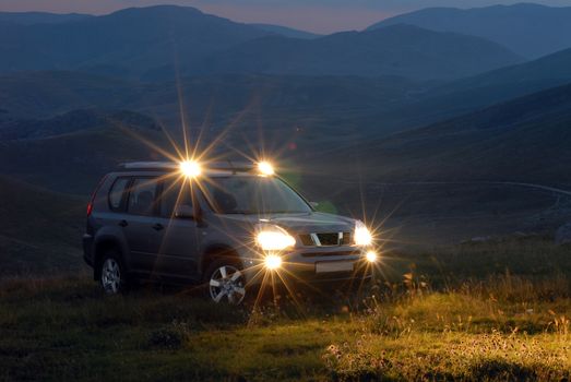 SUV on the mountain with the lights on