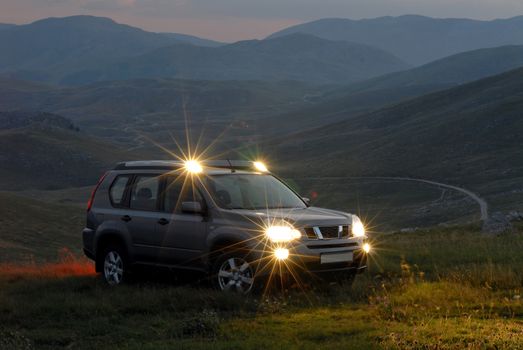 SUV on the mountain with the lights on