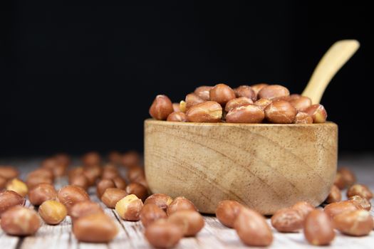 Peanuts peeled in a wooden bowl (Choose the focus, the beans that are in a wooden bowl) Cereal nourishing nourishment Food for health lovers