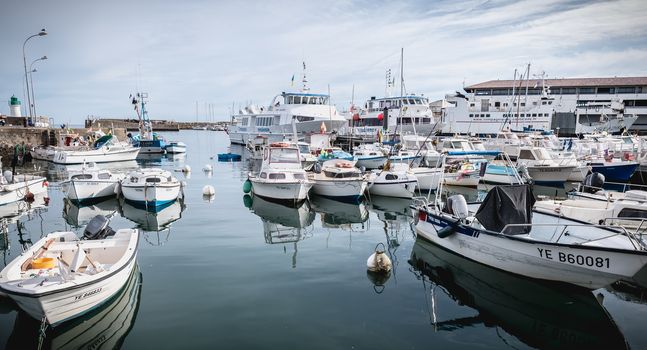 Port Joinville on the island of Yeu - September 17, 2018: view of the small port where maneuver fishing boats, tourism boats and sea shuttles going to the mainland on a summer day