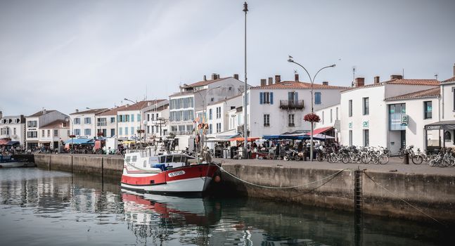 Port Joinville on the island of Yeu - September 17, 2018: view of the small port where maneuver fishing boats, tourism boats and sea shuttles going to the mainland on a summer day