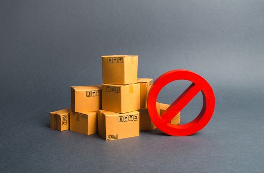 Many cardboard boxes and a red symbol NO. Embargo, trade wars. Restriction on the importation of goods, proprietary for business. Inability to sell products, ban on the import. No delivery.