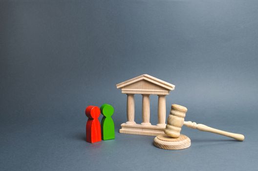 Two figures of people opponents stand near the courthouse and the judge's gavel. Conflict resolution in court, claimant and respondent. Court case, settling disputes. The judicial system.
