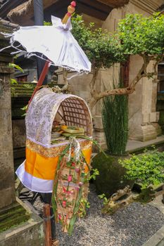 Altar woven from bamboo wicker, covered with white cloth with gold pattern. Offerings to the Gods stored inside a Hindu altar, Bali, Indonesia. Culture and religion of Balinese believers.
