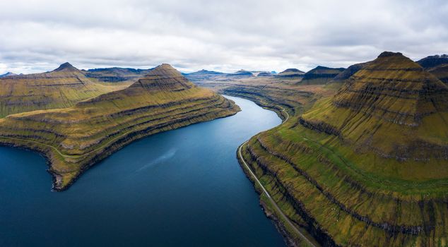 Aerial panorama of spectacular fjords near the village of Funningur photographed from the Hvithamar mountain in Faroe Islands, Denmark.