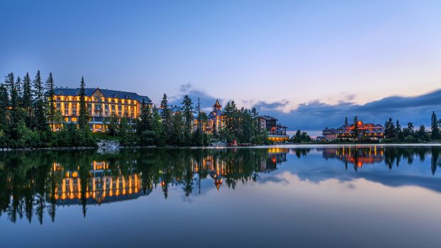 Sunset over glacial mountain lake Strbske Pleso in National Park High Tatra, Slovakia. Long exposure.