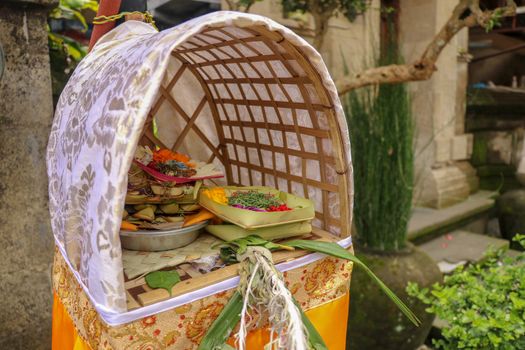Altar woven from bamboo wicker, covered with white cloth with gold pattern. Offerings to the Gods stored inside a Hindu altar, Bali, Indonesia. Culture and religion of Balinese believers.
