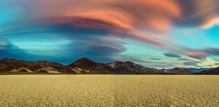 Scenic sunset at Racetrack Playa  in Death Valley National Park. The Racetrack Playa is a scenic dry lake with moving stones that inscribe linear imprints. Long exposure.