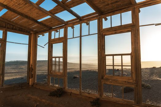 Sunrise at the ruins of historic mining town named Kolmanskop located in the Namib desert near Luderitz in Namibia, Southern Africa