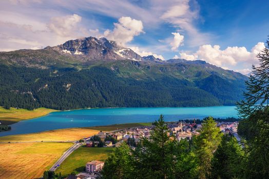 Silvaplana Lake also known as Silvaplanersee with many athletes using the wind to fly over water. Silvaplana is a town in the Maloja Region in the Swiss canton of Graubunden, Switzerland.