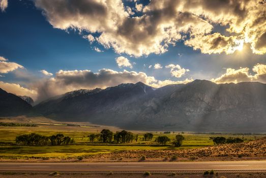 Play of lights and clouds before sunset above Sierra Nevada from route 395 in California, USA