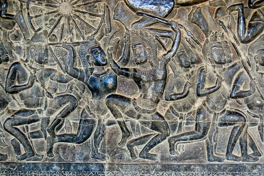 An ancient bas relief frieze on a wall of Angkor Wat Temple in Siem Reap, Cambodia. Showing the Battle of Kurukshetra between the Pandava and Kaurava clans at the conclusion of the Mahabharata.