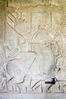 Bas relief sculpture of three cavalry soldiers on horseback. South Gallery, west section Angkor Wat temple, Siem Reap, Cambodia.
