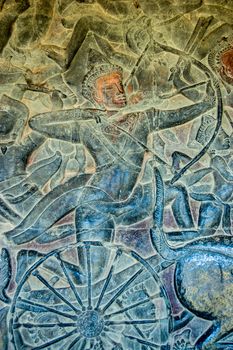 Bas relief sculpture on a wall of Angkor Wat temple, Siem Reap, Cambodia. An archer is shown in battle riding on a chariot fighting in the Battle of Kurukshetra as described in the Mahabharata.