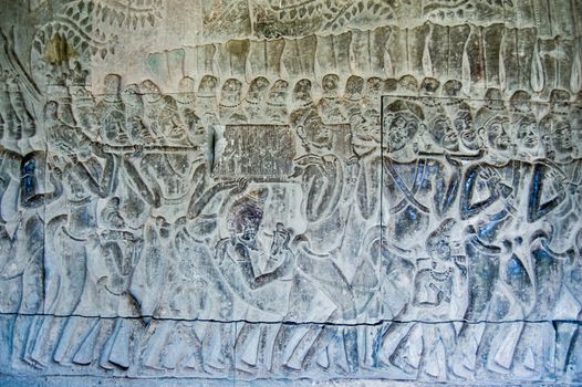 Bas relief carving of a procession carrying an ark with religious significance. Inner wall at Angkor Wat Temple, Siem Reap, Cambodia.