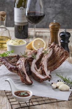 Grilled pork ribs with mashed potatoes placed on a wooden table.