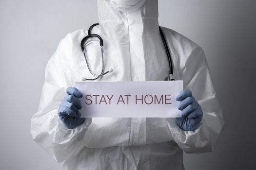 A doctor with a paper with stay at home holding on hand, protect from Coronavirus or Covid-19 epidemic