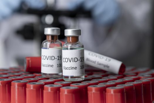 Nobel coronavirus covid-19 vaccine vial a illustrative picture, doctor in the laboratory with a biological tube for analysis and sampling of Covid-19 infectious disea.