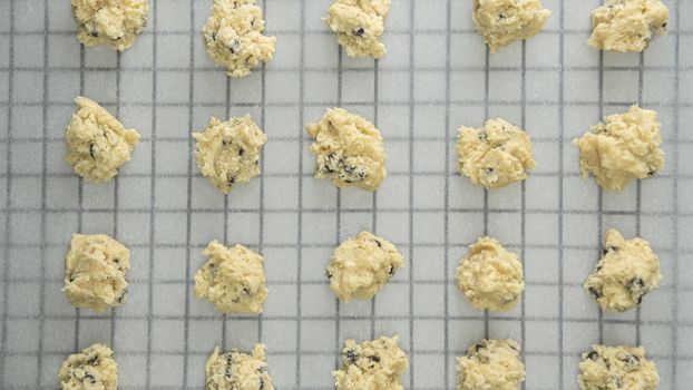 Directly Above Shot Of Chocolate Chip Cookies On Cooling Rack At Table, Preparing chocolate chip cookies