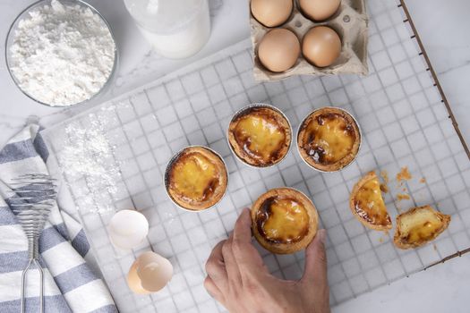 Egg tart, traditional Portuguese dessert, pasteis de Nata Portuguese Custard Tarts food on a Cooling Rack. Typical custard pies.