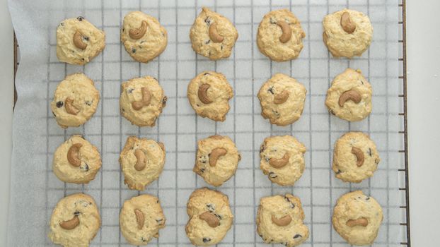 Directly Above Shot Of Chocolate Chip Cookies On Cooling Rack At Table, Preparing chocolate chip cookies