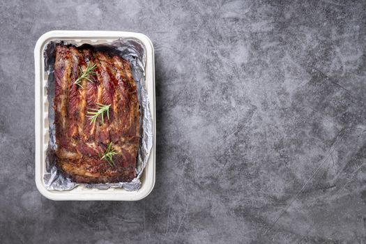 Grilled pork ribs with Vegetables and sauces on a drak table.