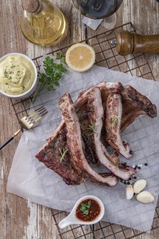 Grilled pork ribs with mashed potatoes placed on a wooden table.