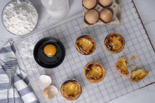 Egg tart, traditional Portuguese dessert, pasteis de Nata Portuguese Custard Tarts food on a Cooling Rack. Typical custard pies.