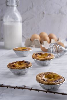 Egg tart, traditional Portuguese dessert, pasteis de Nata Portuguese Custard Tarts food on a Cooling Rack. Typical custard pies.