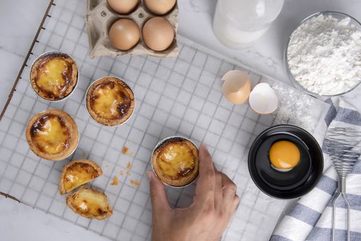 Egg tart, traditional Portuguese dessert, pasteis de Nata Portuguese Custard Tarts food on a Cooling Rack. Typical custard pies.