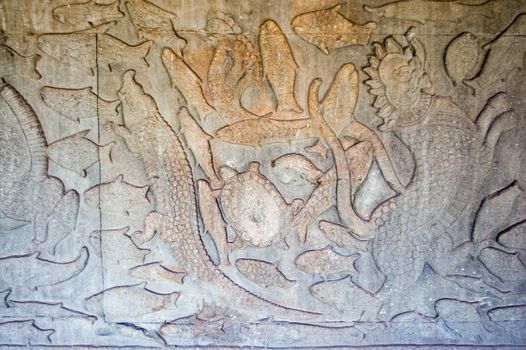 Ancient Khmer bas relief carving of sea creatures. Churning of the Ocean of Milk gallery, Angkor Wat temple, Siem Reap, Cambodia.