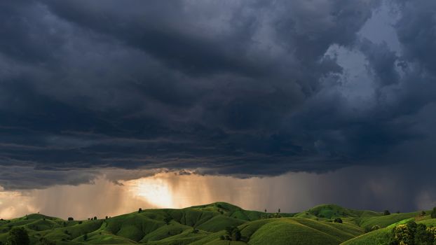 Dark storm clouds sky. Mountain corn plantations in northern Thailand, a thunderstorm with the rain, nature Background, Dark ominous grey storm clouds. Dramatic sky ray.