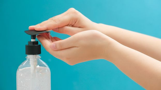 close up of Woman using hand sanitizer gel alcohol for clean hands coronavirus protection.