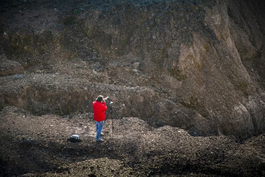 Nature photographer traveler taking photo of beautiful landscape. From top of the mountain.