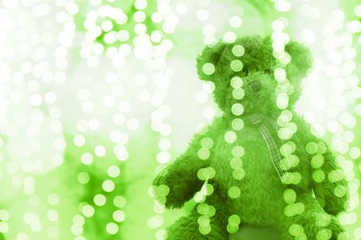 Teddy bear doll in Lighting line bokeh green white bright for Christmas or happy new year Background, Bear in glitter Green background Blurred bokeh bright (Selective Focus)