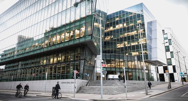 Dublin, Ireland - February 12, 2019 - cyclists passing by the Irish social seat of Facebook's international social network on a winter day