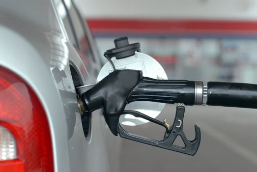 Putting gasoline in vehicle (gas station), fuel nozzle at a gas station