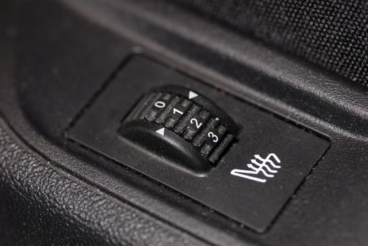 automotive seat with a rotary switch that regulates heating