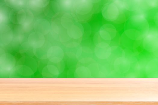 empty wood table floors on blurred bokeh soft green gradient background, wooden plank empty on green bokeh colorful light shade, colorful bokeh lights gradient soft for banner advertising products