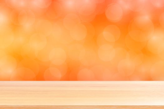 empty wood table floors on blurred bokeh soft orange gradient background, wooden plank empty on orange bokeh colorful light shade, colorful bokeh lights gradient soft for banner advertising products