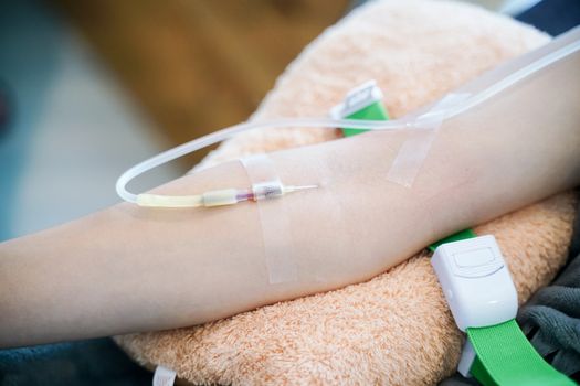 closeup needle injection vitamins and minerals directly into bloodstream